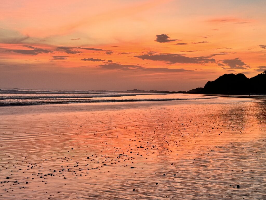 Beautiful orange and pink sunset at the Pura Vida Retreat, a unique mother daughter retreat in Nosara, Costa Rica.